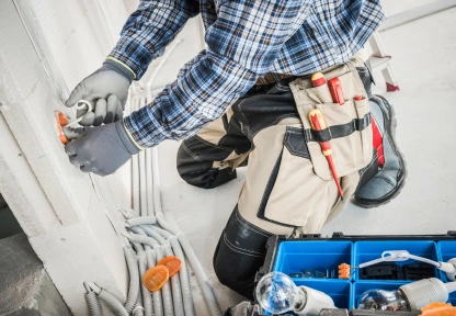 Building maintenance technician working on electrical wiring