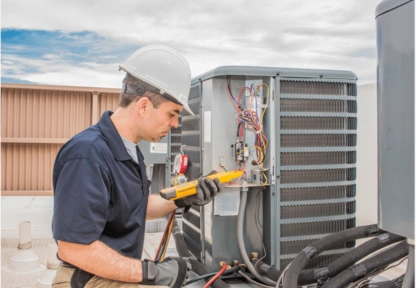 HVAC technician servicing an outdoor air conditioning unit in the UAE